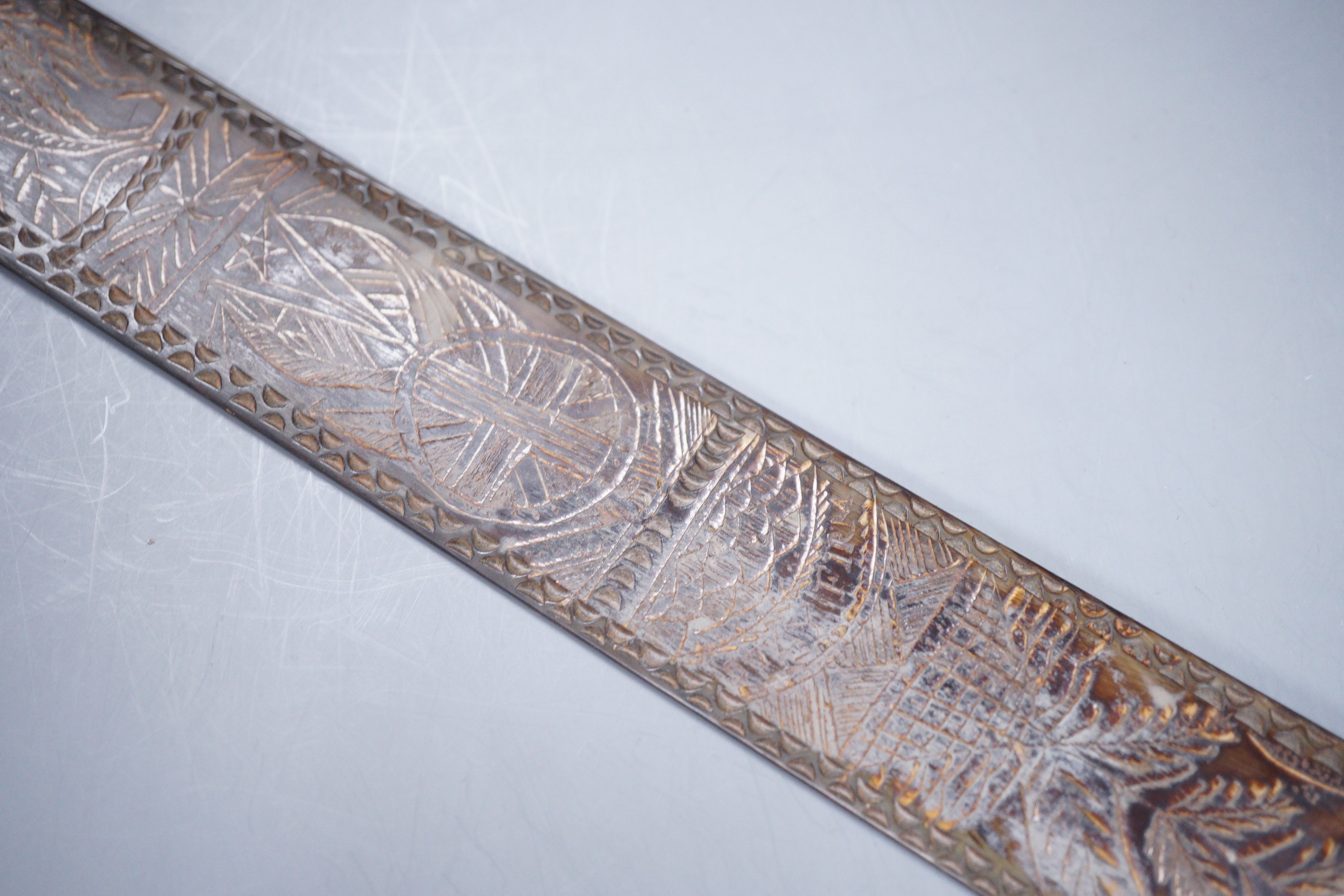 A 19th century carved horn page turner with bone inset roundels, 30.5cm